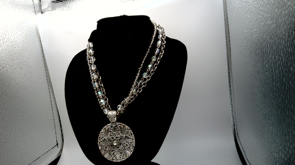 Vintage Avon Nancy and Rise Triple Strand Necklace with Silver tone Filigree Medallion along with Rhinestones.